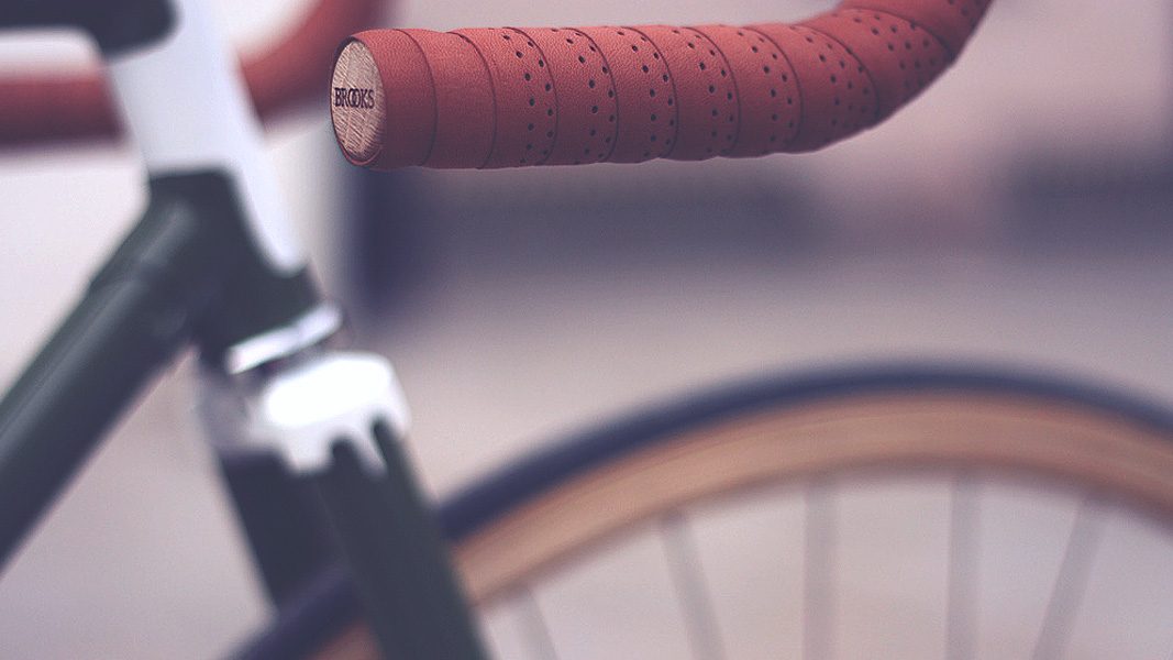 Close-up of brown handlebar tape on a black bike